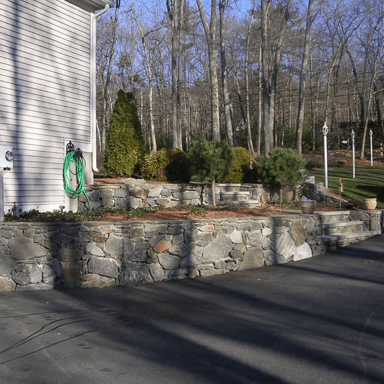 custom stone patio surrounded by plantings