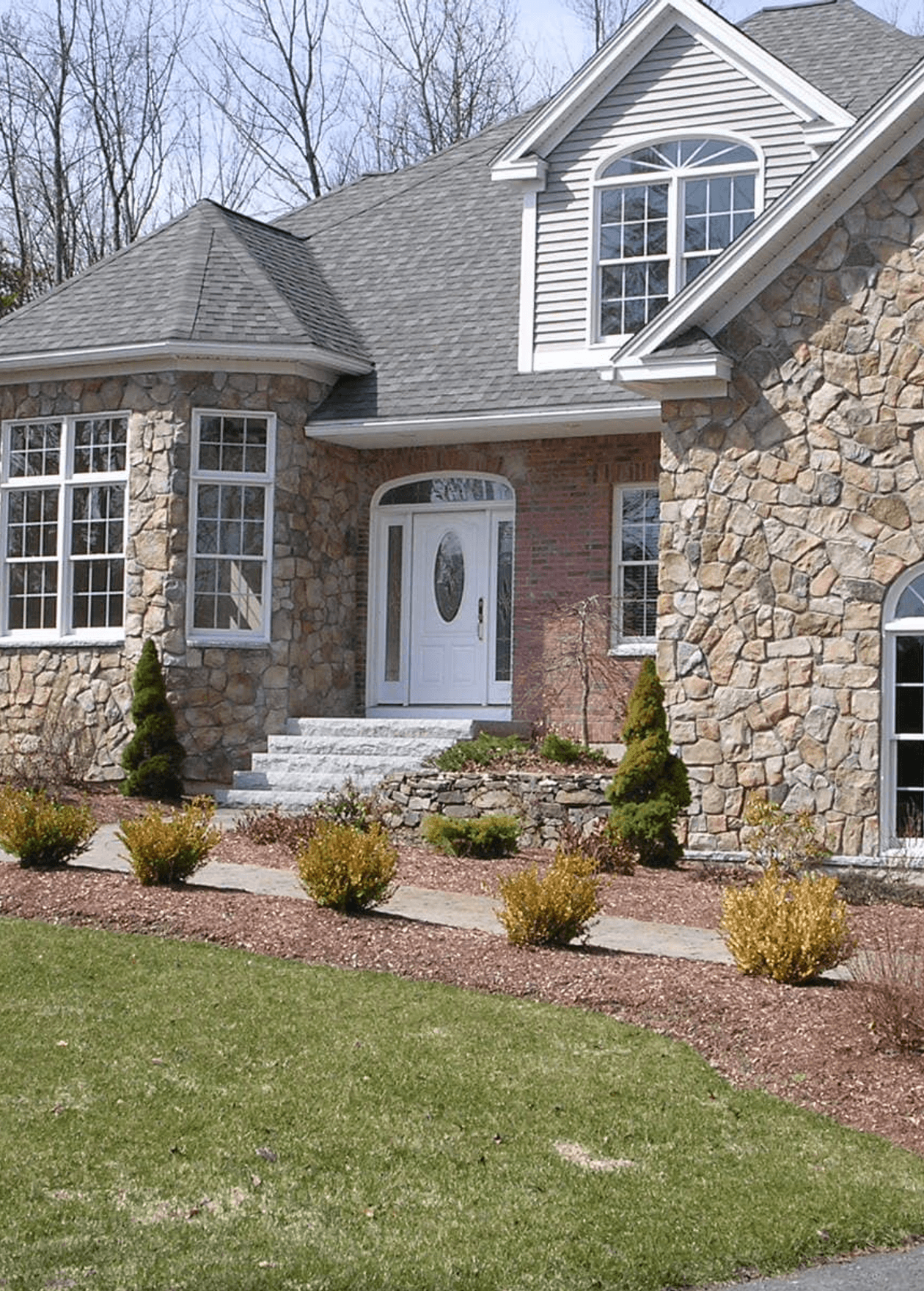 stone mason installing a natural stone retaining wall
