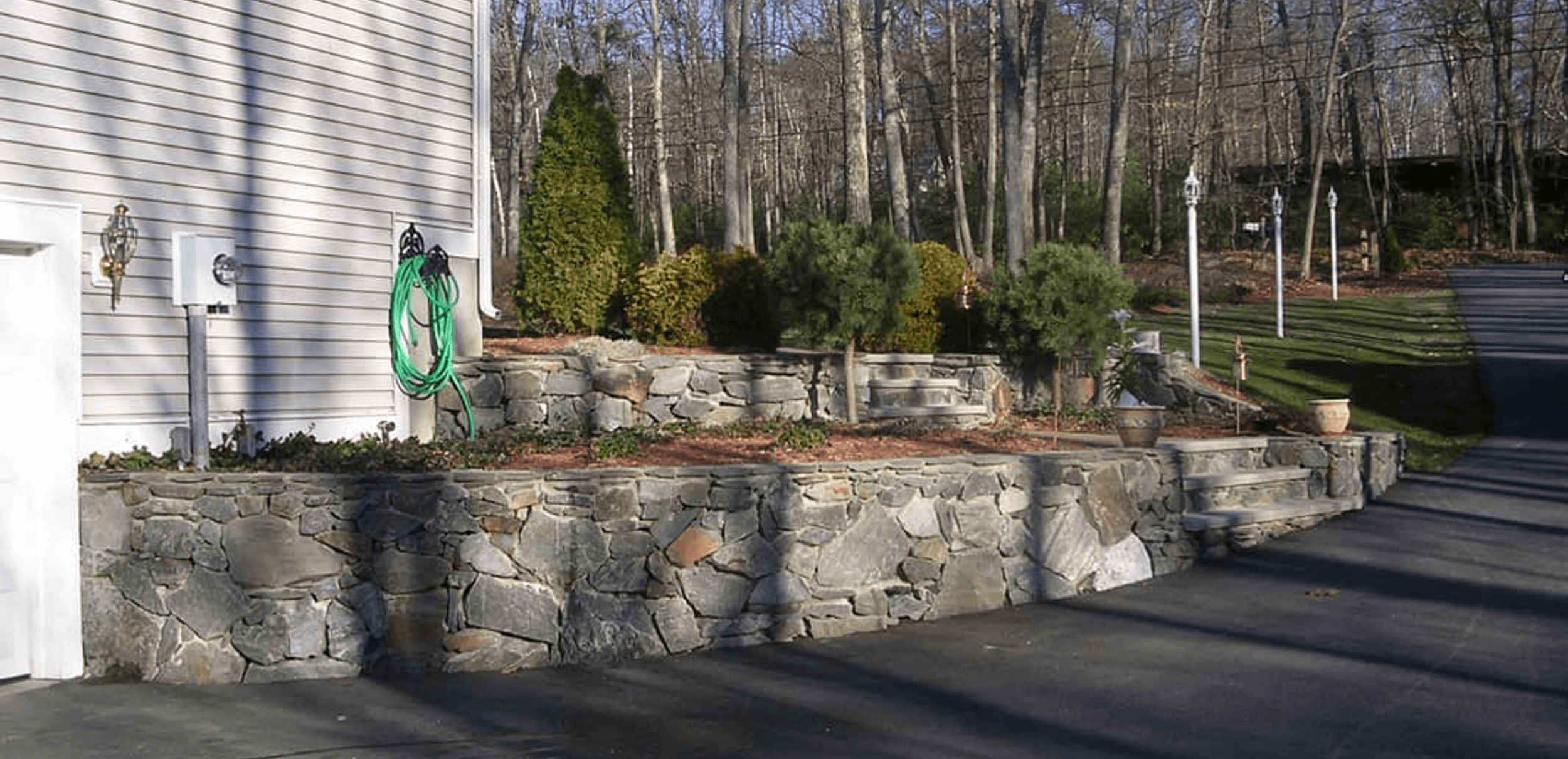 completed stone wall in a manicured yard